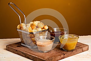 Closeup shot of Noisette potatoes with various sauces shot of photo