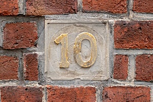 Closeup shot of a number 10 in the wall