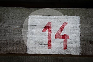 Closeup shot of number 14 on a wooden surface