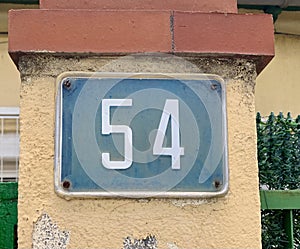 Closeup shot of number "54" in the address on the building wall