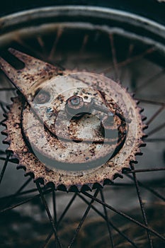 Closeup shot of the old, aged and rusty parts of the hub and the spokes of the bicycles