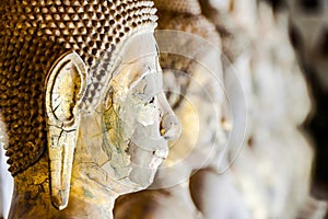 Closeup shot of an old chipped Buddha statue face