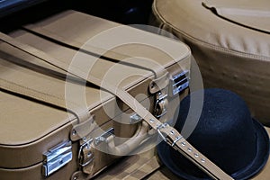 Closeup shot of an old leather suitcase in the trunk of an old car