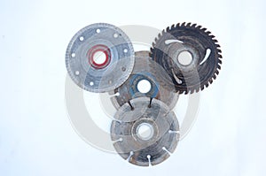 Closeup shot of old metal gears and round blades isolated on a white background