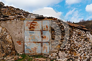 Closeup shot of an old metal rusty and abandoned farm door