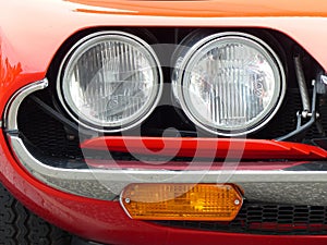 Closeup shot of an old red car headlights