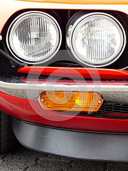 Closeup shot of an old red car headlights