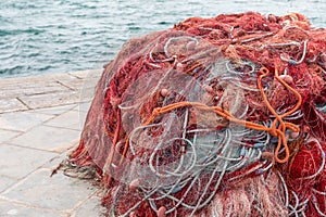 Closeup shot of old red fishing nets in Porto Cesareo, Italy