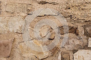 Closeup shot of an old stone wall in Asissi, Italy photo