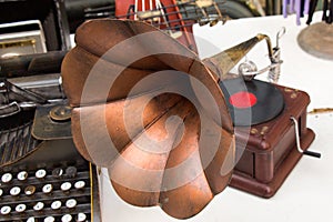 Closeup shot of an old vintage gramophone and a typing machine