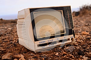 Closeup shot of an old vintage TV abandoned on a beach