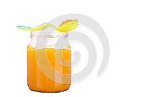 Closeup shot of an orange baby food bank isolated on white background