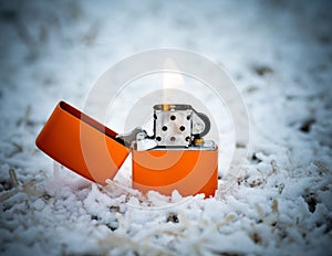 Closeup shot of an orange lit cigarette lighter