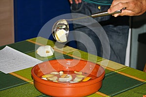 Closeup shot of people making a traditional Galician Queimada punch