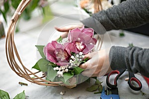 Closeup shot of a person designing a pink decorative bouquet