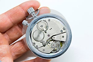 Closeup shot of a person holding an old antiquary timer clock on a white background photo