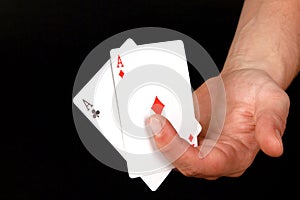 Closeup shot of a person holding two ace cards