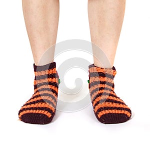 Closeup shot of a person's feet wearing striped orange socks