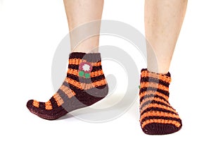 Closeup shot of a person's feet wearing striped orange socks