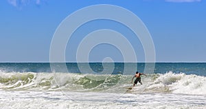 Closeup shot of a person surfing on the waves on the beach in Brazil