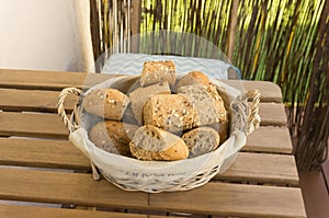 Closeup shot of pieces of fresh bread in a basket on a wooden surface