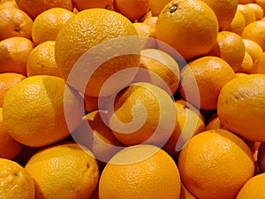 Closeup shot of a pile of fresh oranges displayed in a store