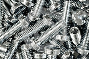Closeup shot of a pile of silver industrial bolts