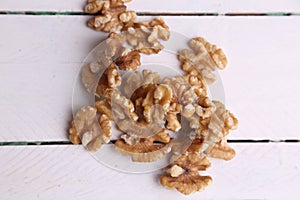 Closeup shot of a pile of walnuts on a wooden surface