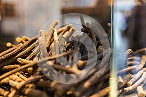 Closeup shot of piled licorice roots sticks in a glass container