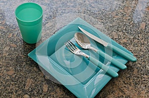 Closeup shot of plastic dishware set with a plate and cutlery