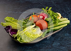 Closeup shot of a plate of fresh vegetables. Ingredients of healthy, vegan salad