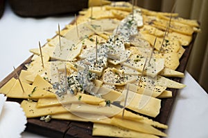 Closeup shot of a plate with a variety of cheese a banquet table