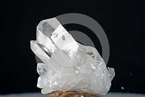 Closeup shot of pure quartz crystal cluster isolated on black background