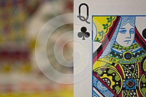 Closeup shot of a queen of clubs card with a blurred background