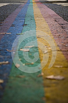 Closeup shot of rainbow colored zebra crossing indicating equal rights for lbgtq community