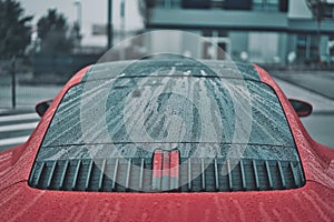 Closeup shot of raindrops on a luxury sport car