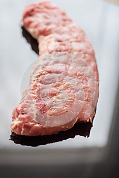 A closeup shot of raw pork ribs being cooked with seasonings photo