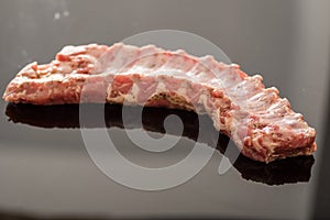 A closeup shot of raw pork ribs being cooked with seasonings photo