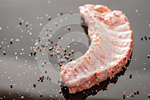 A closeup shot of raw pork ribs being cooked with seasonings photo