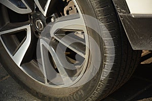 A closeup shot of Rear side view front wheel. A car tire