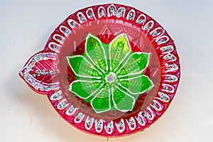 Closeup shot of a red and green Festival Diya Set for Decoration. Handmade Clay Diya for Diwali