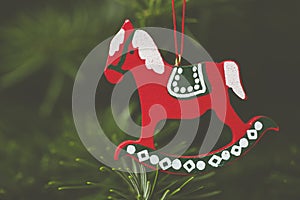 Closeup shot of a red horse Christmas tree ornament with a blurred background