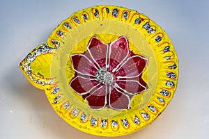 Closeup shot of a red and yellow Festival Diya Set for Decoration. Handmade Clay Diya for Diwali
