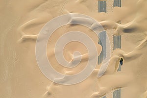 Closeup shot of roads of unfinished construction covered by the desert sands