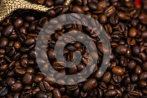 Closeup shot of roasted coffee beans in a burlap sack