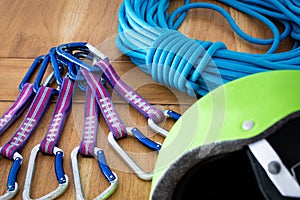 Closeup shot of rock climbing equipment under the light: ropes, quickdraws, helmet