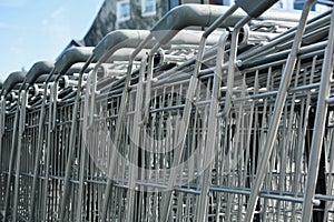 Closeup shot of a row of metal shopping carts