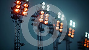 A closeup shot of a row of powerful floodlights standing tall against a dark sky