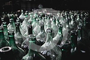 Closeup shot of rows of green bottles in a winery