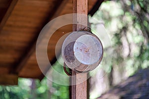 Closeup shot of a rusty old bucket hanging on a wooden pole